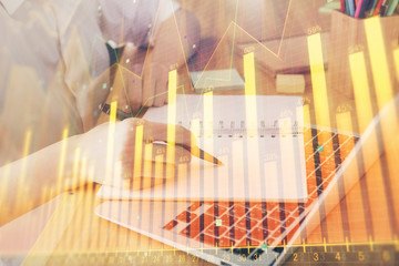 Financial charts displayed on woman's hand taking notes background. Concept of research. Double exposure