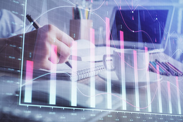 Financial chart drawn over hands taking notes background. Concept of research. Double exposure