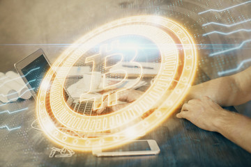 Blockchain theme hologram with man working on computer on background. Concept of crypto chain. Double exposure.