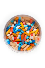 Container with a collection of colorful pills on a white background