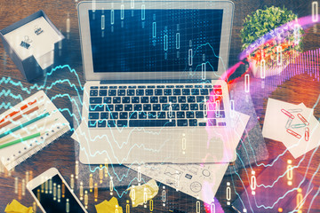 Multi exposure of graph and financial info and work space with computer background. Concept of international online trading.