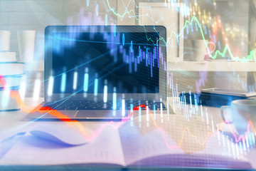 Stock market graph on background with desk and personal computer. Double exposure. Concept of financial analysis.