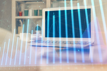 Stock market chart hologram drawn on personal computer background. Multi exposure. Concept of investment.