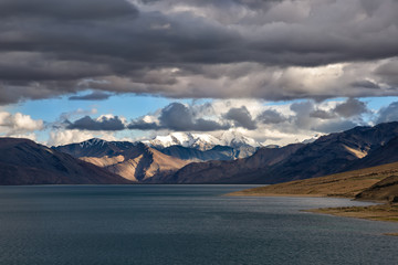 Fototapeta na wymiar Stormy sky over Tso Moriri lake in Ladakh region, India. The lake is at an altitude of 4,522 mt. and accessibility is largely limited to summer season. The area are a protected reserve