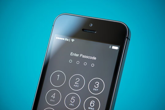 Kiev, Ukraine - September 24, 2014: Close-up shot of Apple iPhone 5S showing four digits pass code security system to prevent unauthorized access.