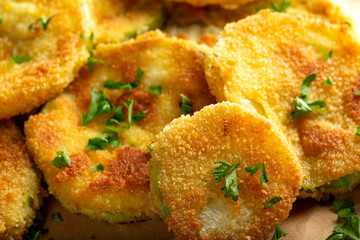 Fried slices of zucchini with green chopped parsley