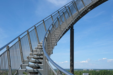 Career steps: a steep upward flight of stairs in front of a blue sky