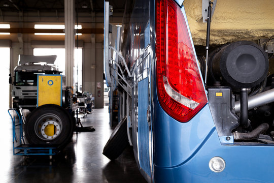 bus and truck waiting for service and maintenance in the garage. automobile and transportation concept.