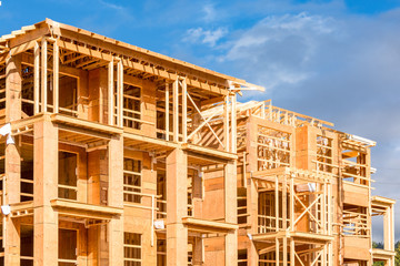 Apartment building under construction on sunny day on blue sky background.