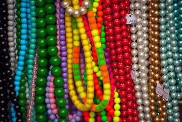 Necklace of colorful stones on the table. Many different jewelry and beads made of natural precious...