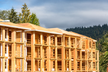 New apartment building under construction on sunny day on blue sky background.