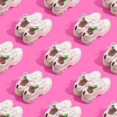 Pair of white sneakers on color background. Sport running concept. Many shoes seamless pattern
