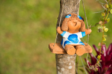 Baby dolls made from clay in garden.Thailand.