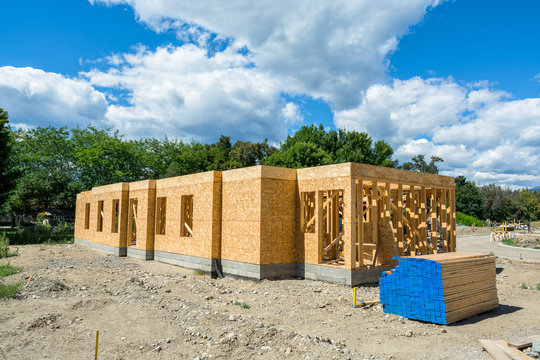 Wooden frame of new building with lumber materials prepared for construction