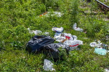 Traces of debris, plastic bags and garbage that fell on the train route