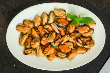 mussels in oil (delicious seafood) portion serving. top food background. copy space