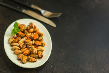 mussels in oil (delicious seafood) portion serving. top food background. copy space