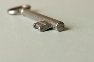 Old key on grey background. Key isolated on grey background.