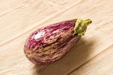 Fresh purple eggplant on wooden table. Natural food.