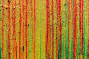 Wall with smudges of multi-colored paint.