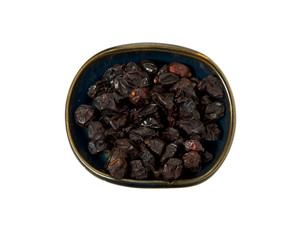 Dried barberry in a bowl isolated on a white background. Seasoning on isolate. View from above. Close up view of dried barberry.