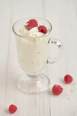 Whipped cream with fresh berry on a white table