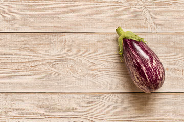 Fresh purple eggplant on wooden table. Natural food.