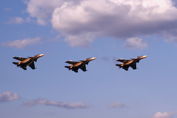Fototapeta na wymiar Three air fighters against sunset sky and clouds
