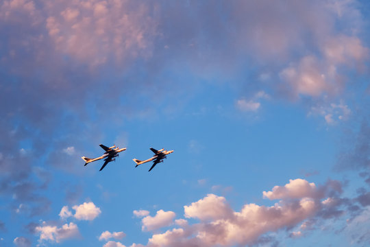 Two propeller airplanes at sunset sky