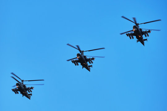 Three helicopters in a diagonal row