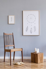 Stylish bohemian interior design of living room with retro chair, rattan slippers, wooden cube, white candles, mock up poster frames and elegant accessories. Modern home decor. Template. Ready to use.