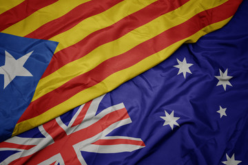 waving colorful flag of australia and national flag of catalonia.