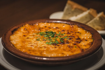 Creamy Tokyo Style Lasagna served in a brown china bowl with bread