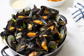 Belgian mussels with potato fries and sauce close up