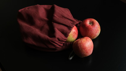 red apples and ranets in a burgundy bag