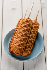 Three corn dogs on plate