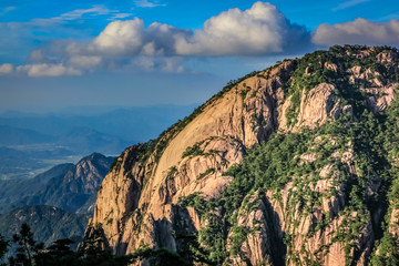 Large smooth round mountain rock on the right with a lush open valley on the left in Huang Shan (黄山, Yellow Mountains) China