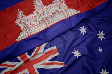 waving colorful flag of australia and national flag of cambodia.