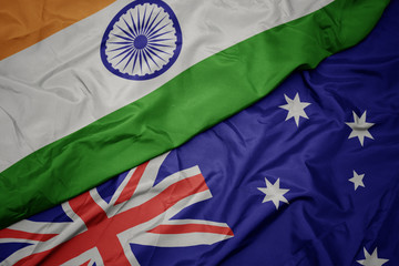 waving colorful flag of australia and national flag of india.