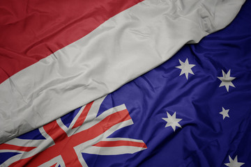 waving colorful flag of australia and national flag of indonesia.