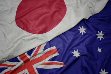 waving colorful flag of australia and national flag of japan.
