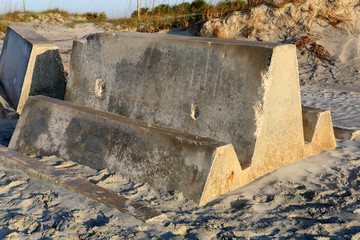 One concrete blocks stored on a beach.