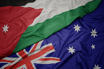 waving colorful flag of australia and national flag of jordan.
