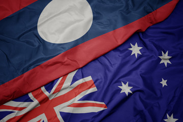waving colorful flag of australia and national flag of laos.