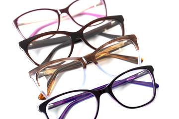 Four pairs of plastic fashionable eyeglass frames. Isolated