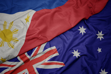 waving colorful flag of australia and national flag of philippines.