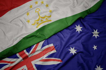 waving colorful flag of australia and national flag of tajikistan.