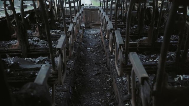 Bus after the fire. Explosion of a bomb in a passenger vehicle. The terrorist act in a bus carrying children. Accident, explosion, set fire. Burnt chairs, broken windows. Human sacrifice. Car accident