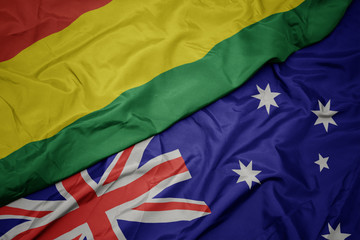 waving colorful flag of australia and national flag of bolivia.