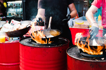 Cooking food in pans at a street festival © alexmia